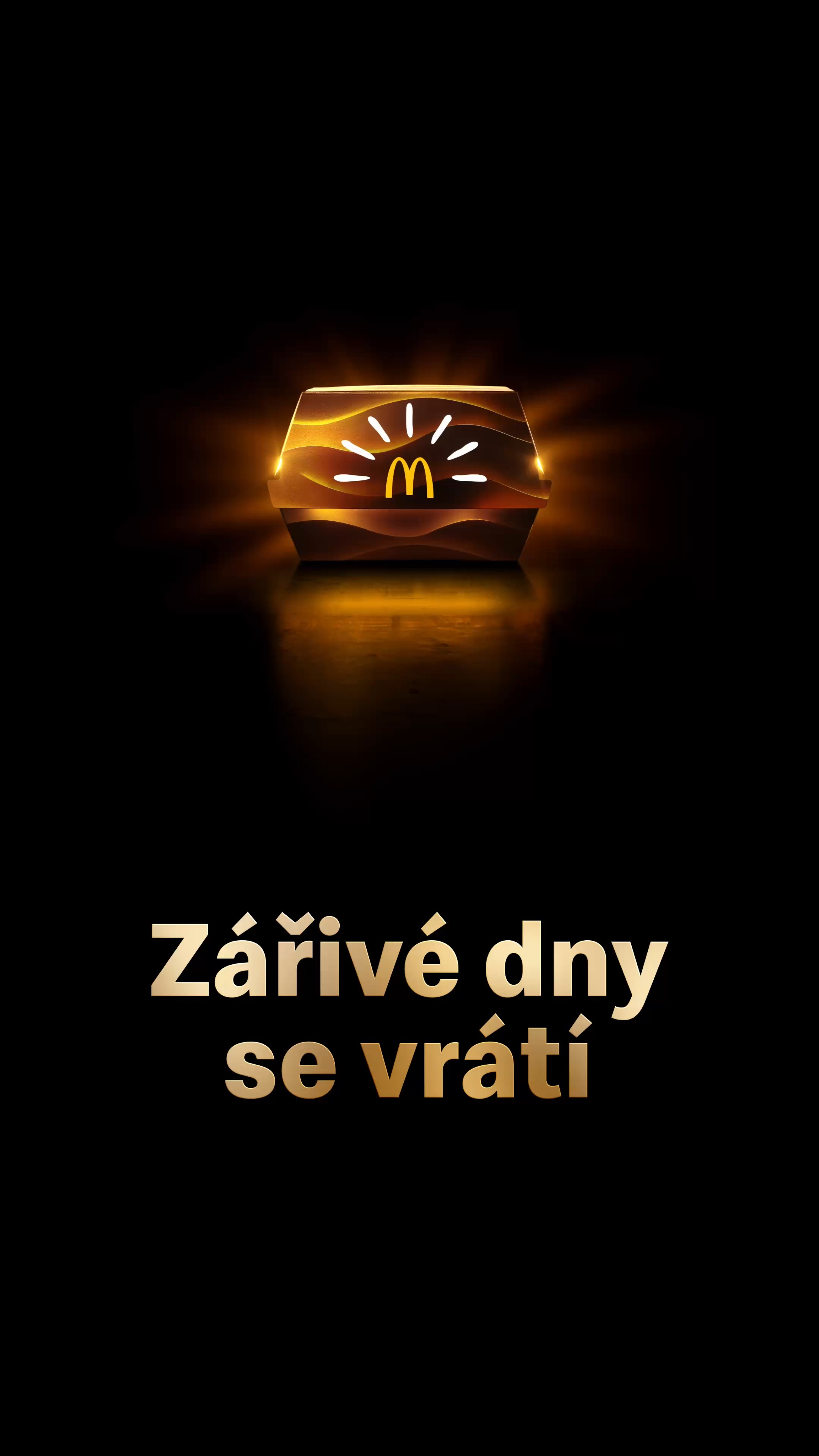 Svítící krabice se zlatými oblouky a paprsky